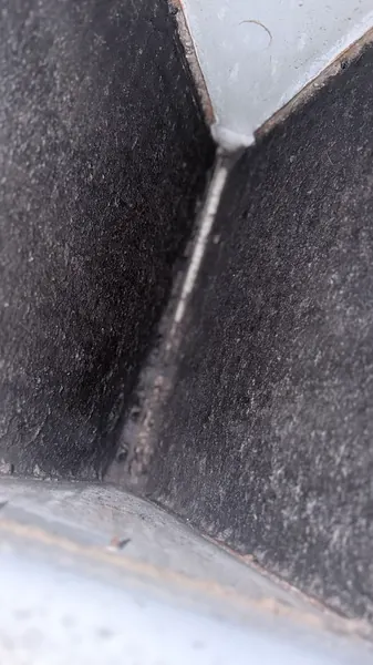 Close-up of heavy dark dust and dirt buildup coating the inside of an AC coil cabinet